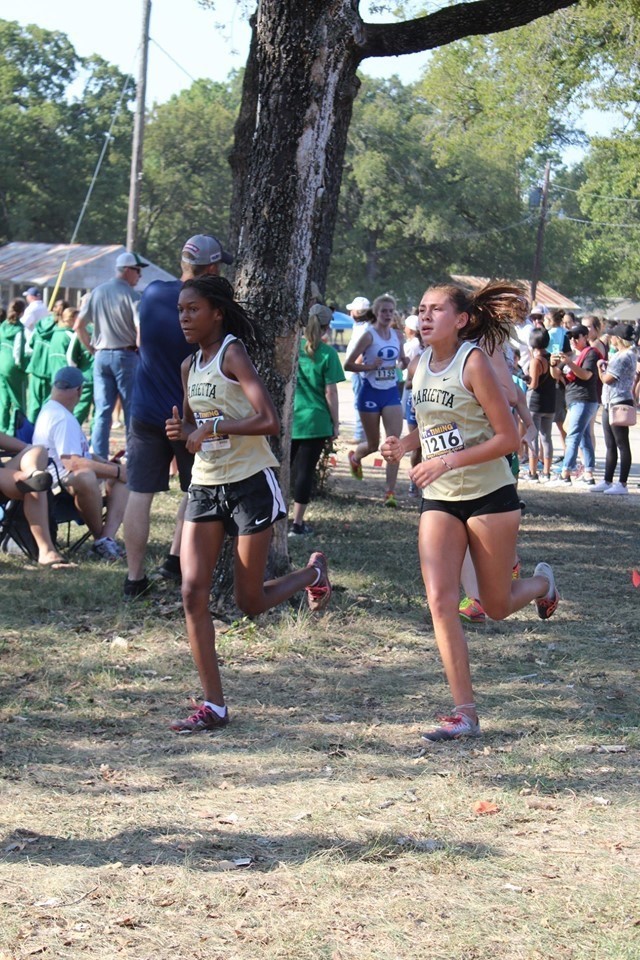 Photo by Bailey Sykora Marietta Lady Indians Cross Country runners Tanasia Randle and Vanessa Rodriguez run in the Decatur Reunion Run on Saturday, October 5. The Lady Indians won the meet, defeating highly ranked Decatur at home.
