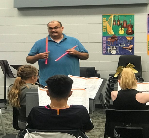 Eric Gallaway helps his beginning band students learn the basics, hoping that they stay with the program until their high school graduation.